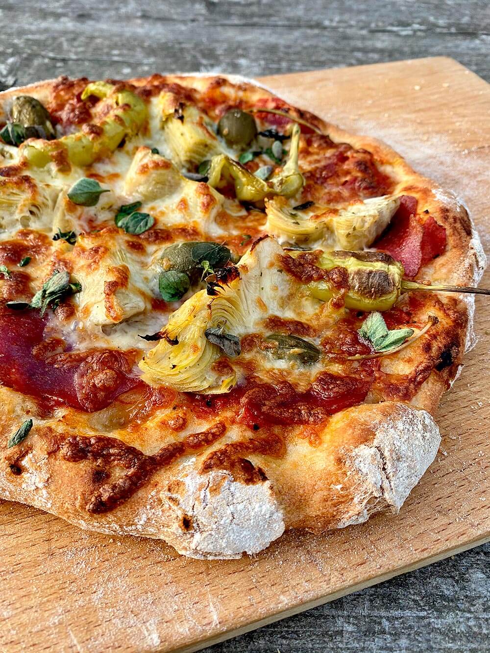 My personal variant of the Capricciosa is the Pizza Rolf with San Marzano tomatoes, salami, artichokes, apple capers, pepperoncini, yellow peppers, mozzarella and oregano. Make your own pizza dough.